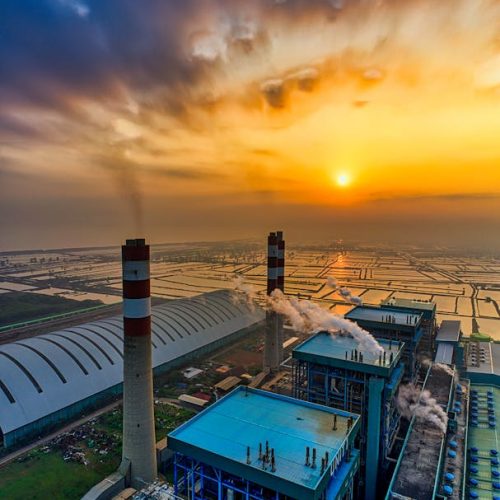 Stunning aerial shot of a refinery in Banten, Indonesia at sunset, showcasing urban industry and golden hour sky.